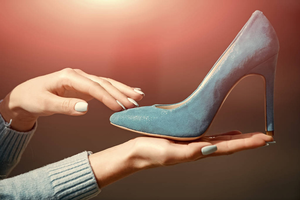 fashion and beauty, shopping and presentation, cinderella. hand with glamour female shoe blue color suede - Foto, Imagen