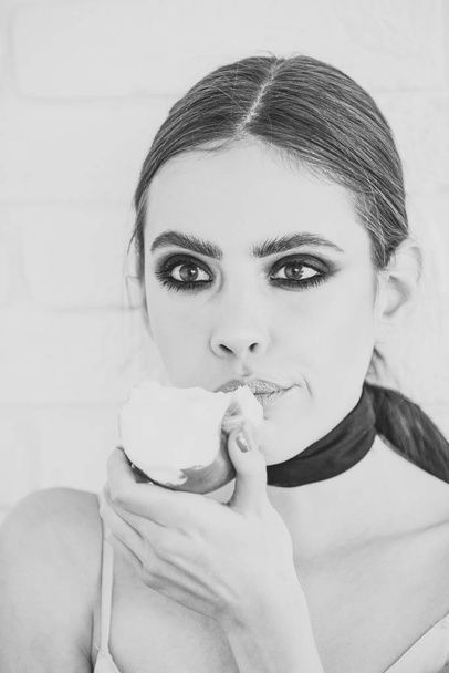 Woman face beauty. Girl hold fruit with smokey eyes face makeup - Foto, imagen