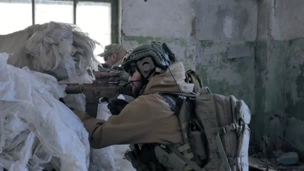 Im Unterstand des alten Gebäudes, dem militärischen Konzept, werden Soldaten in Tarnung mit Kampfwaffen beschossen - Filmmaterial, Video