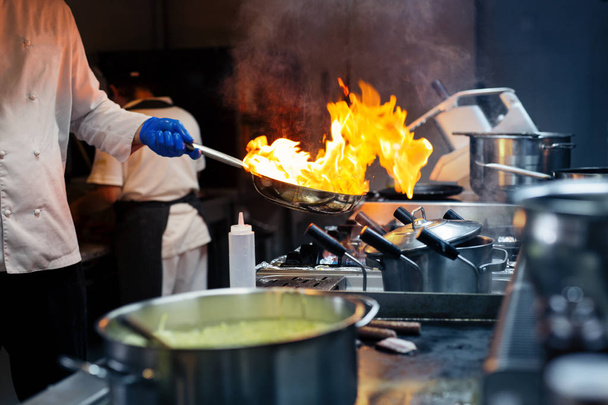 Chef cooking with flame - Фото, зображення