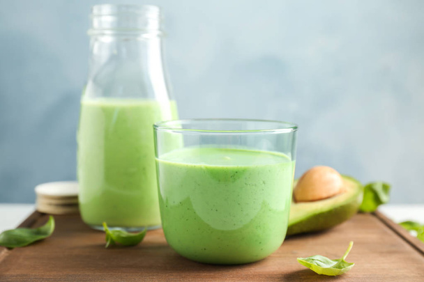 Glassware with healthy detox smoothie and spinach on table - Foto, Bild