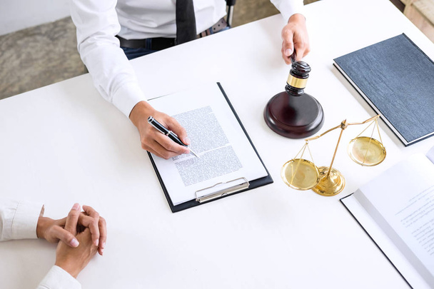 Businesspeople or lawyer having team meeting discussing agreement contract documents, judge gavel with Justice lawyers at law firm in background, Legal law, advice and justice concept. - Photo, Image
