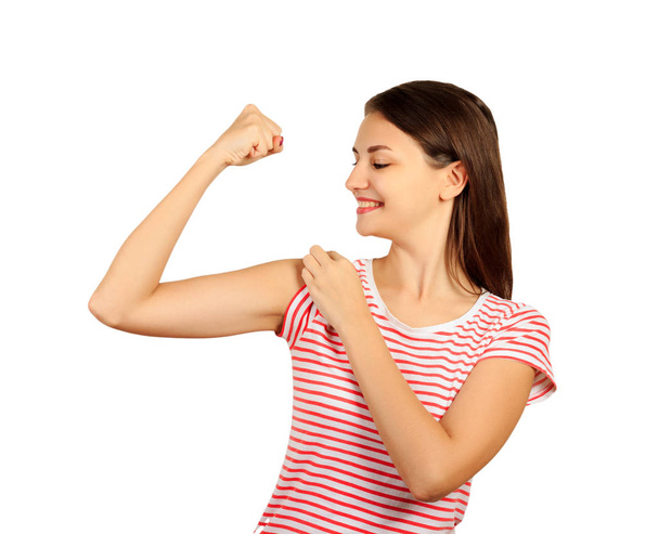 smiling girl is pointing at her bicep. emotional girl isolated on white background. - Φωτογραφία, εικόνα