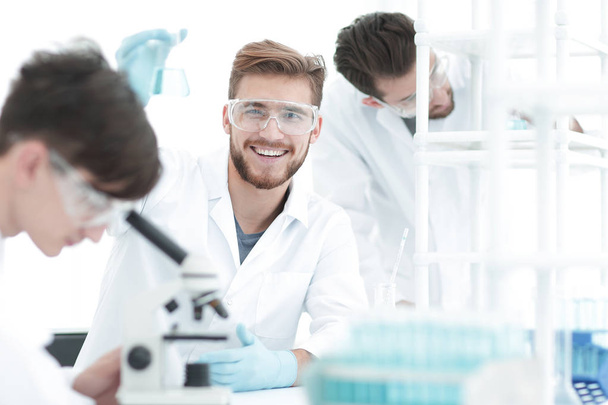 male biologist on blurred background colleagues. - Фото, изображение