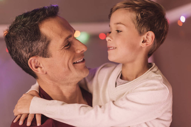 Positive caring father looking at his son - 写真・画像