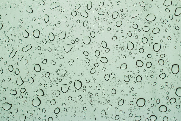 Drops of rain on the tinted windshield of the car. texture - Photo, Image