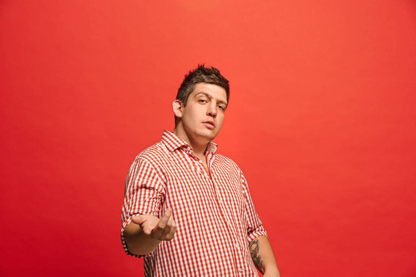 Beautiful male half-length portrait isolated on red studio backgroud. The young emotional surprised man - Foto, immagini