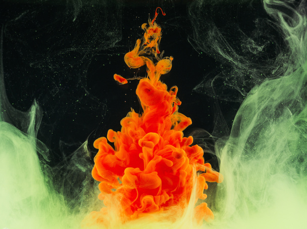 close-up view of bright abstract orange ink explosion on black - Photo, Image