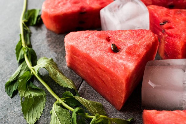 Watermelon Slices with Ice Cubes and Mint Leaves. Organic Summer Fruit. - Fotó, kép