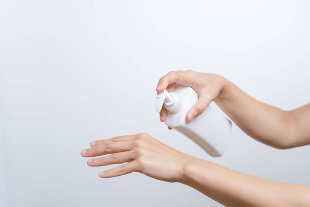 Body Lotion Skin Care Apply. women hands holding body cream pump bottle. Beauty And Body Care Concept - 写真・画像