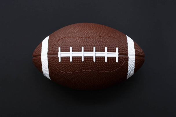 アメリカン フットボールは、黒の背景に分離されました。スポーツ オブジェクトという概念 - 写真・画像