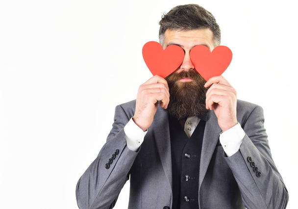 Valentine cards. Hipster with long beard holds red hearts, valentine cards - Fotoğraf, Görsel