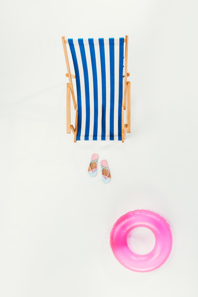 top view of striped beach chair, flip flops and inflatable ring isolated on white - Fotoğraf, Görsel