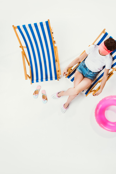 vista aérea de la mujer descansando en silla de playa aislado en blanco, concepto de vacaciones de verano
 - Foto, imagen