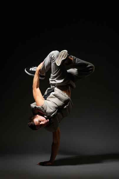 hip-hop dancer standing on one hand - Фото, зображення