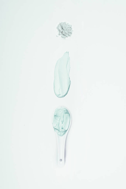 flat lay with clay powder, smudge and spoon with clay mask isolated on white surface  - Foto, imagen