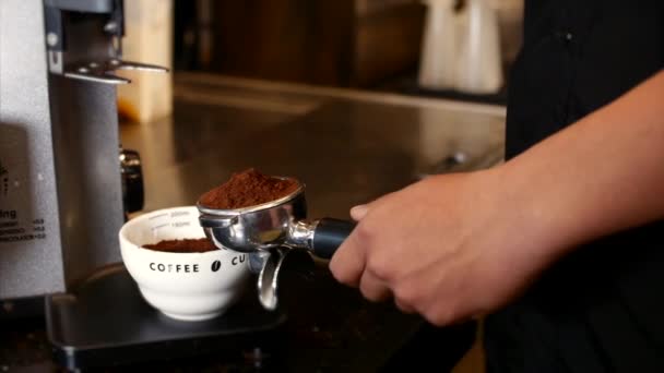 Making Ground Coffee with Tamping fresh coffee. Close-Up. Professional barista. Tamping Fresh Ground Coffee. Stock footage. - Materiaali, video