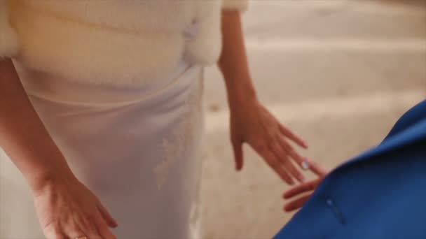 A loving couple holds hands on their wedding day - Záběry, video