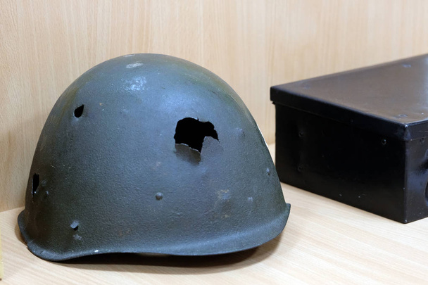 Shallow depth of field. Soldier's helmet of a warrior of the USSR of the times of the Great Patriotic War with bullet holes . - Photo, Image
