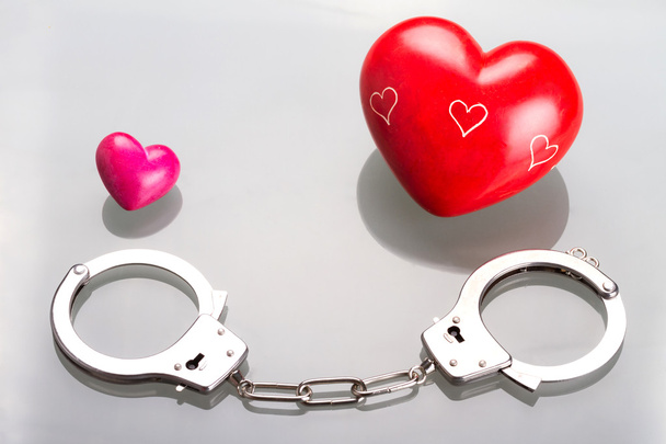 Love symbol in handcuffs - Фото, зображення