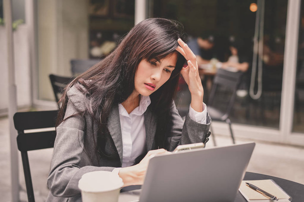 Business Concept. Young businessmen are feeling bad. Young businesswoman is sick. Asian business girl is stressed about her work. Businesswomen are unhappy at work. - 写真・画像