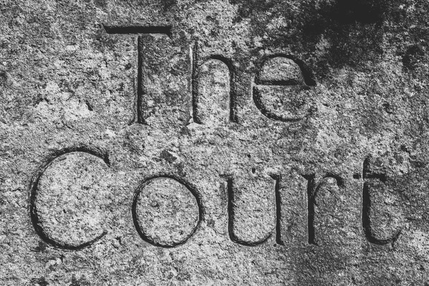 The Court Word Carved In Stone, shallow depth of field black and white high contrast photography - Photo, Image