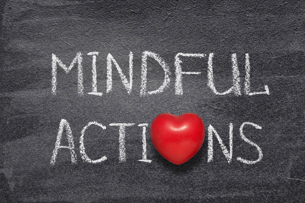 mindful actions phrase handwritten on chalkboard with red heart symbol instead of O - Photo, Image