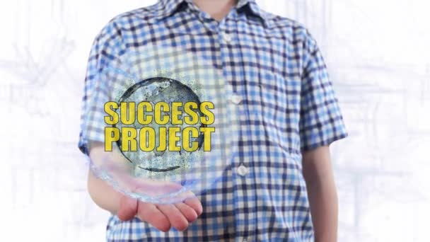 若い男は地球という惑星のホログラムとテキスト成功プロジェクトを示しています - 映像、動画