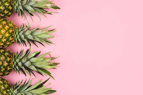Pineapple fruit side border on a pastel pink background. Top view, flat lay with copy space. - Zdjęcie, obraz