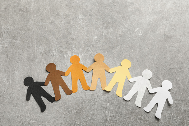 Paper people holding hands on grey background, top view. Unity concept - Foto, imagen