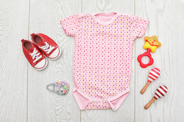 Flat lay composition with baby clothes and accessories on wooden background - Φωτογραφία, εικόνα