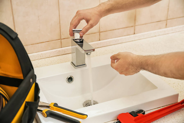 Professional plumber fixing sink, closeup of hands - Фото, зображення