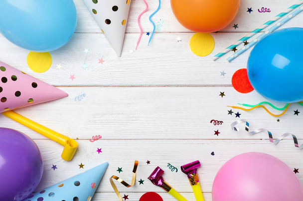 Flat lay composition with birthday party items on wooden background - Foto, afbeelding