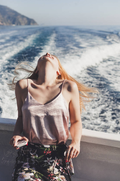 Happy young amazing woman wearing relaxing on the yacht in Cinque Terre, Italy, Ligurian Sea, outdoor - Foto, Imagem