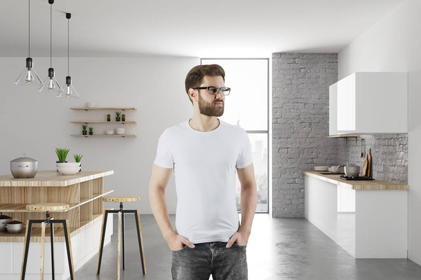 Portrait of handsome thoughtful young man standing in modern kitchen interior. Lifestyle and home concept. 3D Rendering  - Zdjęcie, obraz