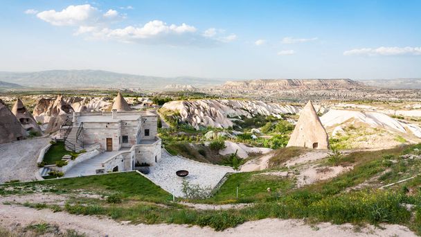 Travel to Turkey - modern and ancient rock-cut buildings in Uchisar town in Cappadocia in spring - Photo, Image