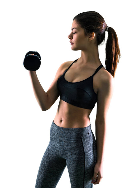 Joven chica deportiva haciendo levantamiento de pesas
 - Foto, imagen