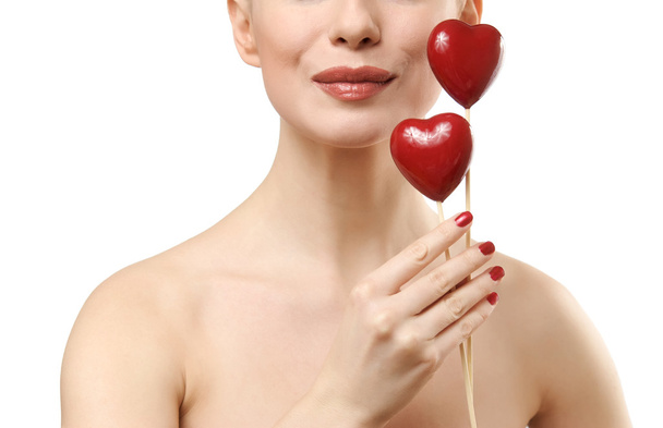 Beautiful woman holding two red hearts. - Fotografie, Obrázek