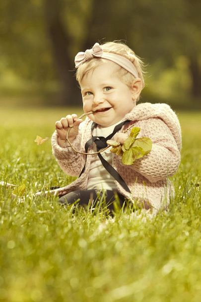 Ten months old girl baby posing in sunny summer park for portrait photo - Photo, image