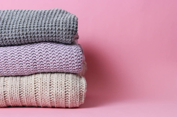 an ideal stack of warm clothes on a monophonic background. minimalism. - Photo, image