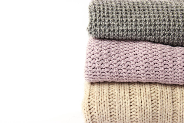 an ideal stack of warm clothes on a monophonic background. minimalism. - Foto, Imagem