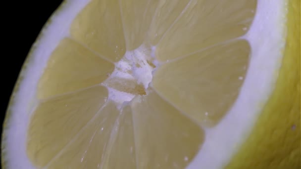 Kesip sarı limon - makro yakın çekim bir siyah arka plan üzerinde görünümü - Video, Çekim