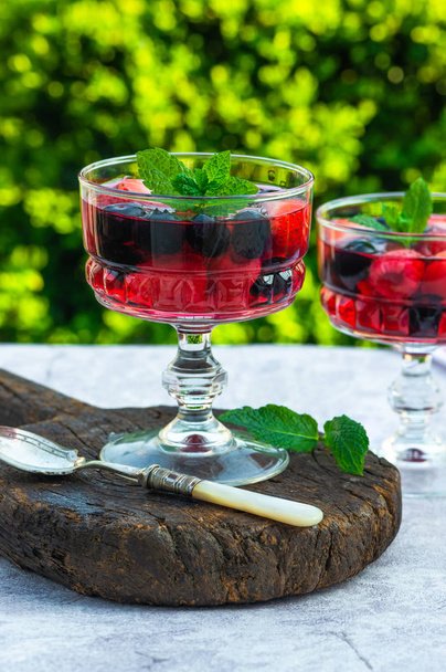Fruit jelly with summer berries garnished with fresh mint - Photo, Image