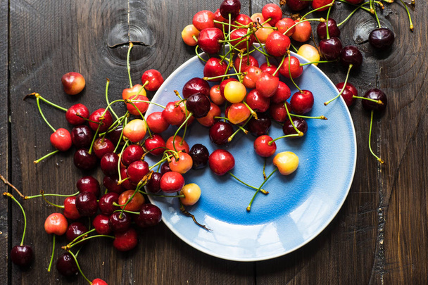 Fresh organic sweet cherries on ceramic bowl with copy space - Photo, Image