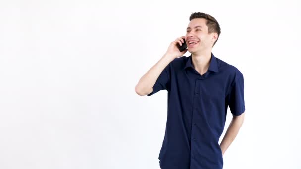 Happy man layghing on white background while talking to the phone - Кадры, видео