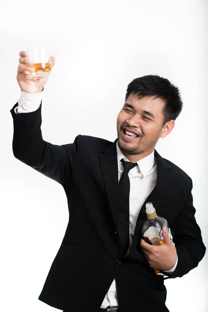 drunk business man holding whiskey bottle with alcoholism problem. Modern person looking messy with alcohol abuse and addiction concept. Isolated on white backgroud with blank copy space - Photo, Image
