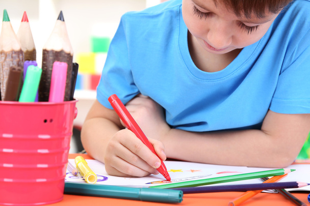 Cute little boy drawing in his notebook - 写真・画像