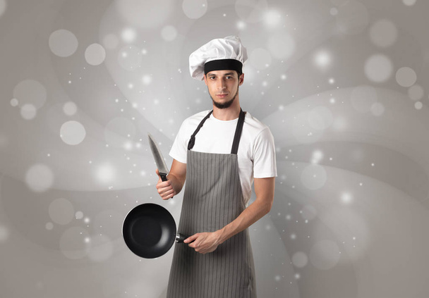Male cook with shiny grey wallpaper - 写真・画像