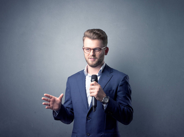 Businessman holding microphone - Zdjęcie, obraz