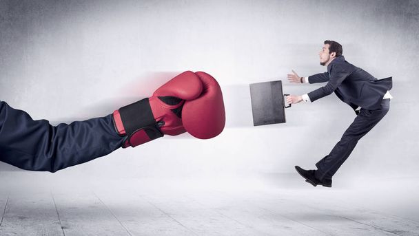 Huge Boxing Gloves punches businessman concept - Foto, afbeelding